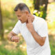 Man checking pulse outdoors on sunny day