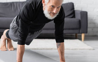 older bearded and tatted man doing push ups