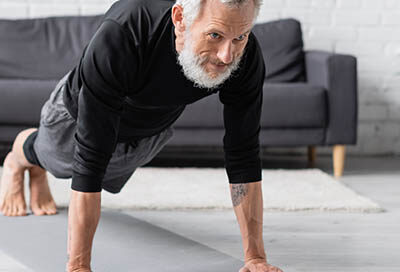 older bearded and tatted man doing push ups