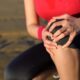 Woman in sports attire experiencing knee pain | Denver Stem Cell