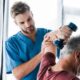 Doctor helping old man doing arm exercise | Denver Stem Cell Therapy